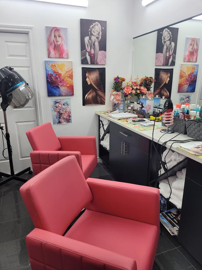 Hair by Easter salon interior with coral chairs and styling station